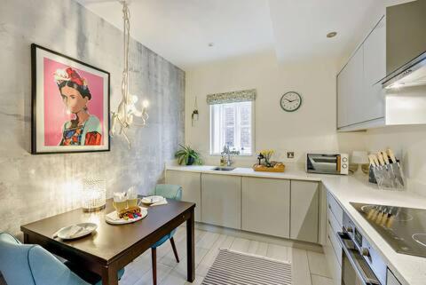a kitchen with a table and a dining room at Beautiful Town Centre Apartment 110 Square Metre With Parking WEEKLY and MONTHLY Reduced Rates in Shrewsbury