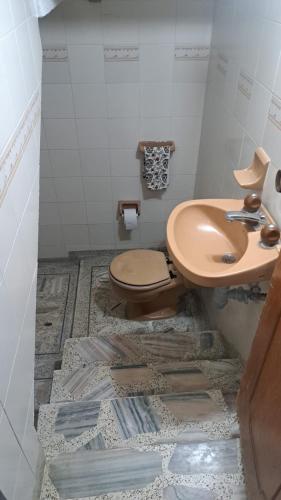 a bathroom with a toilet and a sink at Hotel Casa Franco in Cali