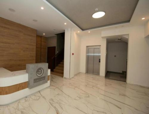 a large lobby with a marble floor and a staircase at Apartmani Katnic in Jagodina