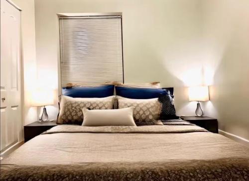 a bedroom with a large bed with two lamps at Entire Apt in Heart of Chicago in Chicago