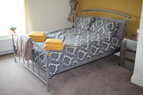 a bedroom with a bed with a metal frame at Hornby Cottage in Saint Michaels on Wyre