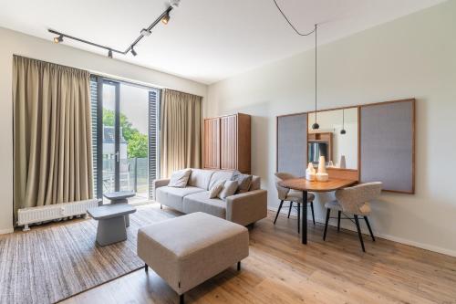 a living room with a couch and a table at Utrecht City Apartments - Huizingalaan in Utrecht