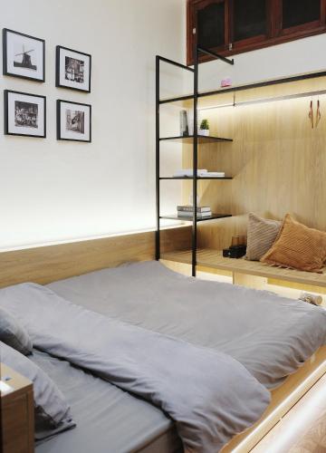 a large bed in a room with a shelf at Toda House - 4Bedroom near Hoan Kiem Lake in Hanoi