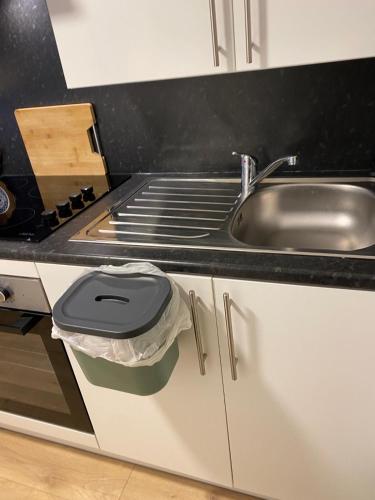 a kitchen with a sink and a counter top at Cosy New Studio 2 min RER B in Aulnay-sous-Bois