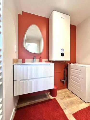 a bathroom with a white sink and a mirror at Le Petit Héros Gîte in Courlay