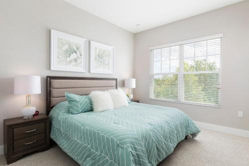 a bedroom with a bed and a window at 4 BR 4 BA Deluxe Villa 5 min to Disney Family getaway in Orlando