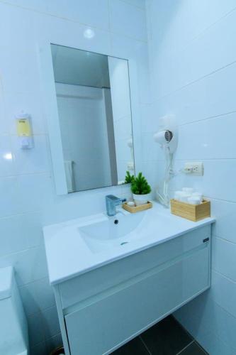a bathroom with a white sink and a mirror at Stunning Beachfront 2BR Condo in Juan Dolio in Juan Dolio