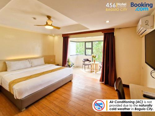 a hotel room with a bed and a television at 456 Hotel in Baguio
