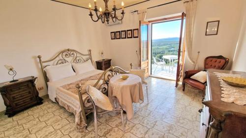 a bedroom with a large bed and a table and a tableablish at Villa Bellavista Palau in Barrabisa