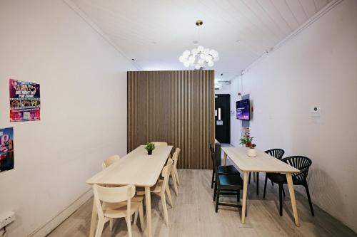 a dining room with two tables and chairs at Urban Nomad Potts Point - 18 to 39 only in Sydney