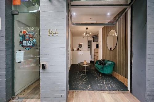 a room with a table and a mirror on the wall at Urban Nomad Potts Point - 18 to 39 only in Sydney
