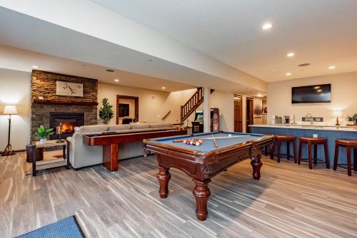 a living room with a pool table and a bar at Cabin Collina by Railey Vacations in McHenry