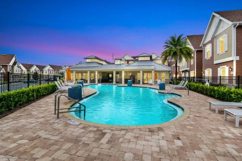 a swimming pool in front of a house at 5 BR 6 BA Luxury Villa 5 min to Disneyworld Hot Tub & BBQ 112 in Orlando