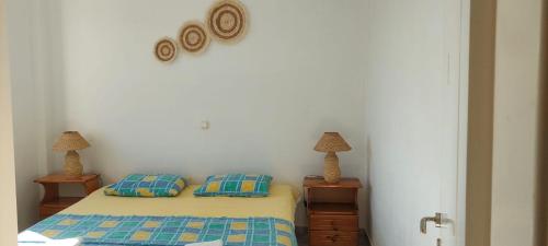 a bedroom with a bed with two night stands and two lamps at APARTMENT Sonia in Análipsis