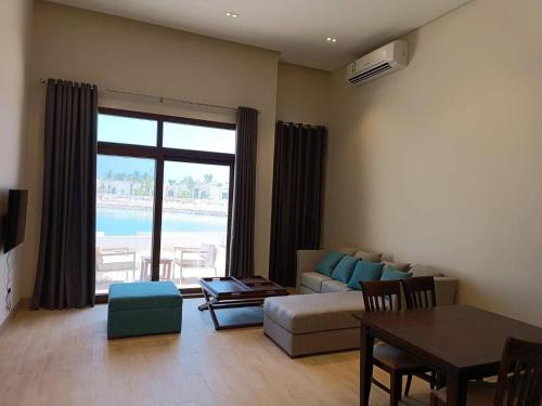 a living room with a couch and a table at Villa - Sleeps 2 - Pool - Parking in Salalah