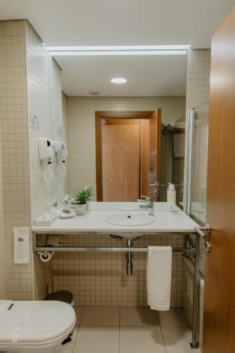 a bathroom with a sink and a toilet at Hotel Sao Sebastiao de Boliqueime in Boliqueime