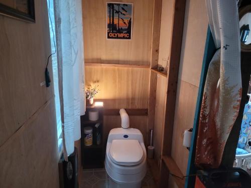 a small bathroom with a toilet in a room at Moss Haven on Hood Canal in Quilcene