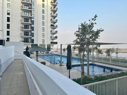 a swimming pool on the balcony of a building at F1 Dreamstay 1BHK Gym Pool in Abu Dhabi