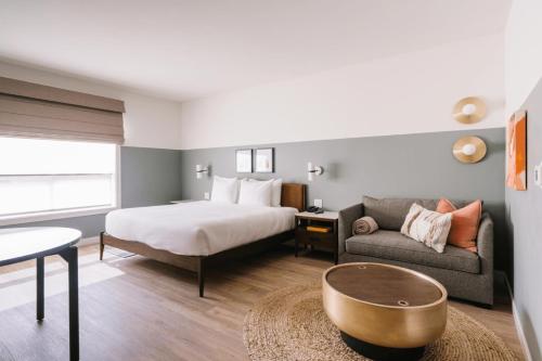 a hotel room with a bed and a couch at Gravity Haus Moab in Moab