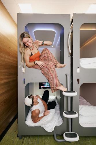 two posters of a woman and a man in a bunk bed at Urban Nomad Potts Point - 18 to 39 only in Sydney