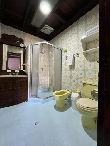 a bathroom with a shower and a toilet and a sink at Hotel Puntalarga PGB in Nobsa