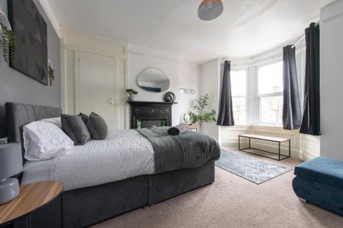 a bedroom with a large bed and a fireplace at The Haven Lodge in Gillingham