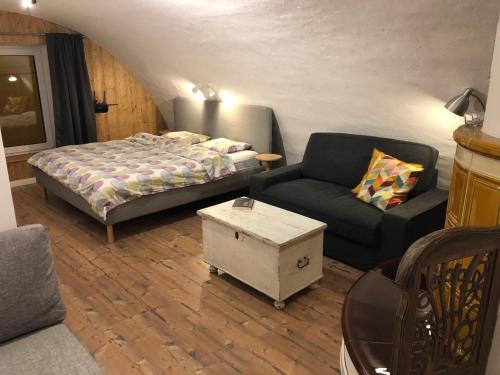 a living room with a bed and a couch at TrailHouse in Liptovský Mikuláš