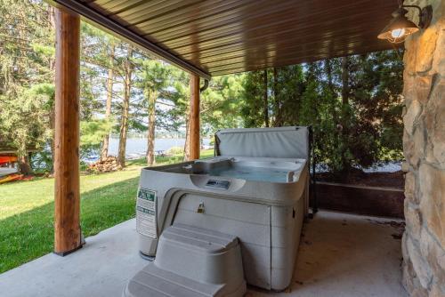 a grill sitting on a patio under a porch at Cedar Shores Villa #06 by Railey Vacations in McHenry