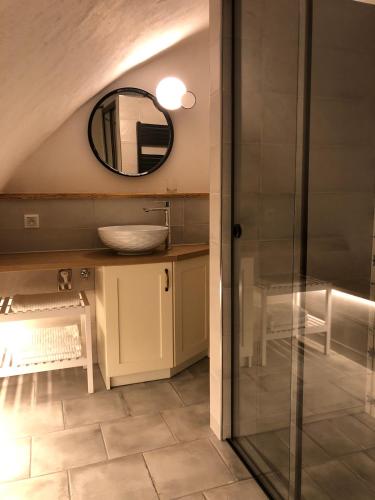 a bathroom with a sink and a mirror at TrailHouse in Liptovský Mikuláš