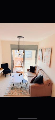 a living room with a couch and a table at ERA home boutique in Eilat