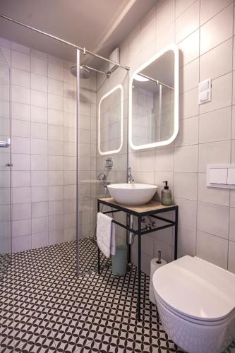 a bathroom with a sink and a toilet at Apartmani Vale in Hvar