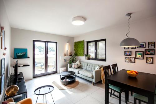 a living room with a couch and a table at Apartmani Vale in Hvar
