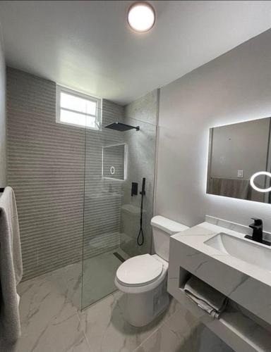 a bathroom with a toilet and a shower and a sink at Luxury Apartment- 3 Bedrooms in Ceiba