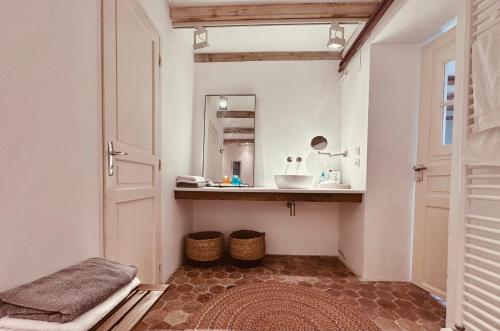 a bathroom with a sink and a mirror at La Cour des Délices in Gigny