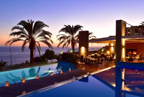 a view of a resort with a swimming pool and the ocean at Pestana Promenade Ocean Resort Hotel in Funchal