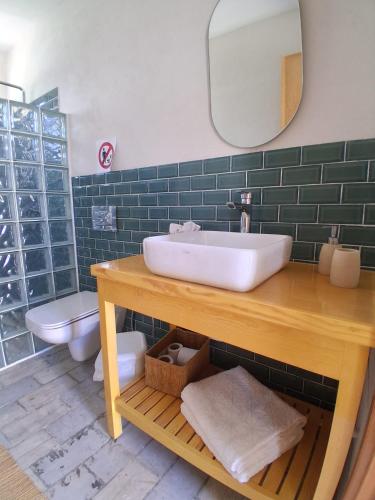 a bathroom with a sink and a toilet at CasaEole B&B in El Haouaria