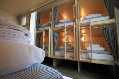 a bedroom with a bunk bed with a mirror at Saintlo Ottawa Jail Hostel in Ottawa