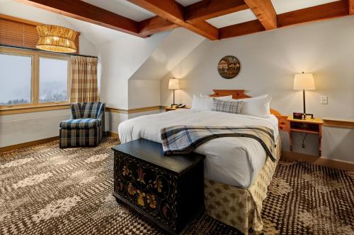 a bedroom with a bed and a desk and a chair at von Trapp Family Lodge & Resort in Stowe