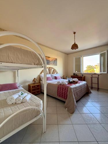 a bedroom with two bunk beds and a window at Aspra Mare House in Aspra