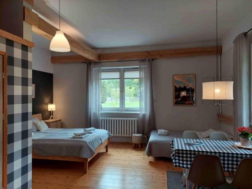 a bedroom with two beds and a window at Przystanek Trześcianka in Trześcianka