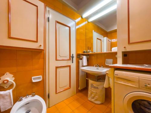 a small bathroom with a toilet and a sink at I cuori in Cortina dʼAmpezzo