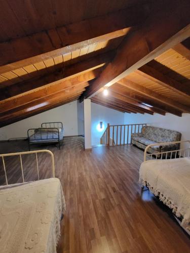 a attic room with two beds and a couch at Casa Martins by Tear in Aldeia de João Pires