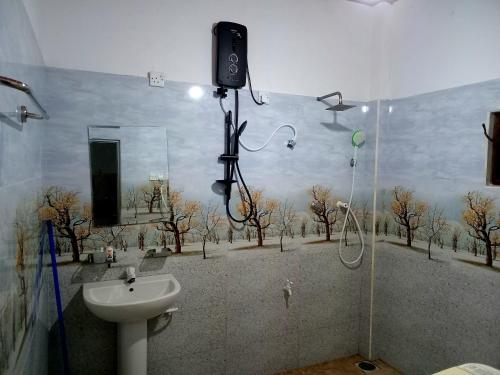 a bathroom with a shower and a sink in a room at Venus Inn Goyambokka in Tangalle