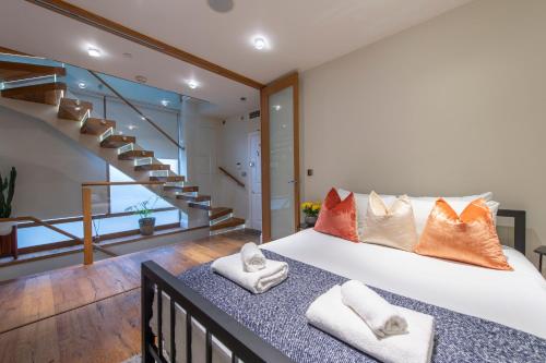 a bedroom with a large bed with pillows at Soho Harmony Haven: Chic 2-Bed, 2-Bath Urban Retreat in London