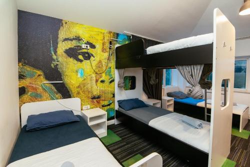 a room with two bunk beds and a mural at Hostel 365 For U in Dubrovnik
