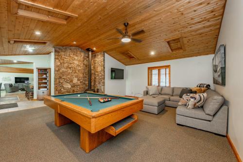 a living room with a pool table in it at Cottage On The Cove by Railey Vacations in Swanton