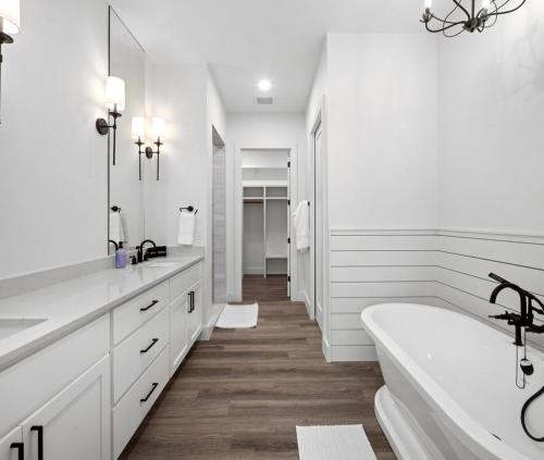 a white bathroom with a tub and a sink at LBJ Retreat in Kingsland