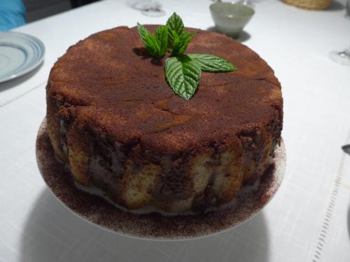 a cake with a green leaf on top of it on a table at Maison de Luciné in Combourg