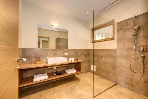 a bathroom with a sink and a shower at Panorama Residence Öhlerhof in Lagundo