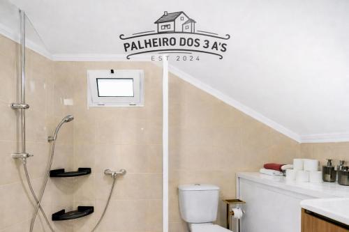 a bathroom with a shower and a toilet and a sink at Palheiro dos 3 A`s in Achadas da Cruz